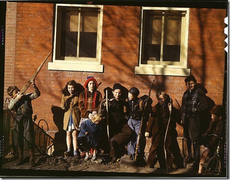 Children aiming sticks as guns, lined up against a brick building. Washington, D.C.(?), between 1941 and 1942. Reproduction from color slide. Photographer Unknown. Prints and Photographs Division, Library of Congress