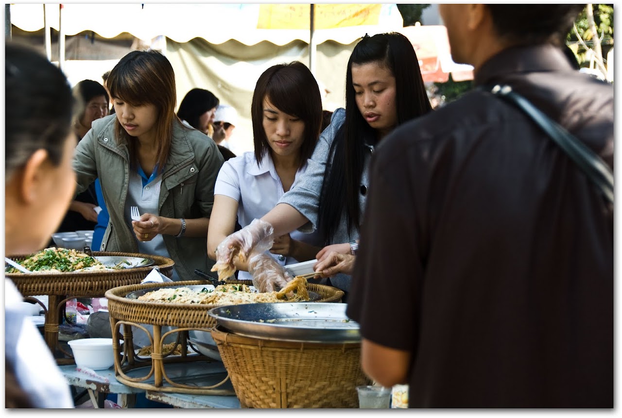 Girls serving noodles