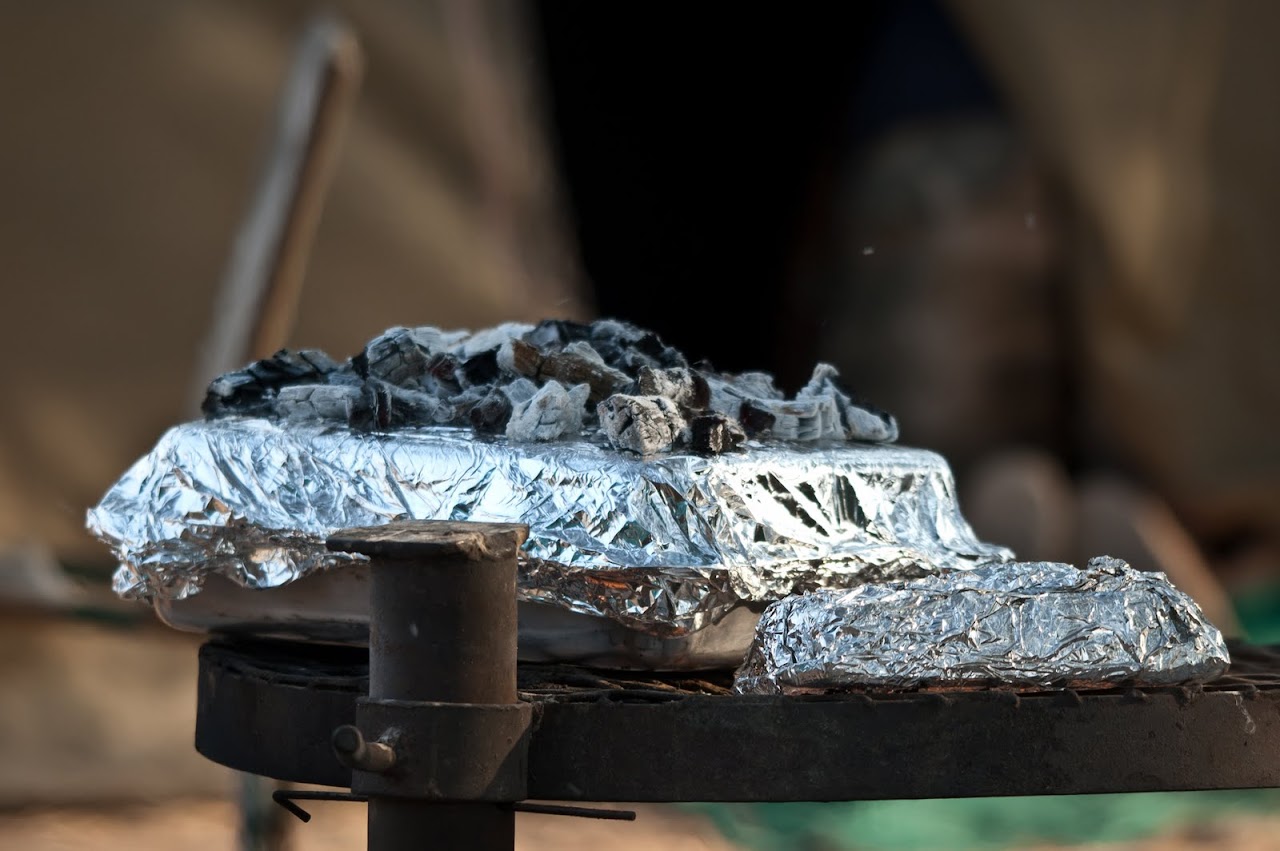 Cake being baked over campfire