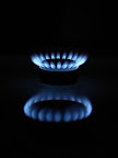Blue flames of gas stove in the dark                                
