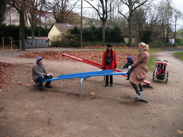 [M L and parents on the blue seesaw[3].jpg]
