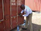 Seal being put in place by customs officer following verification of container contents.