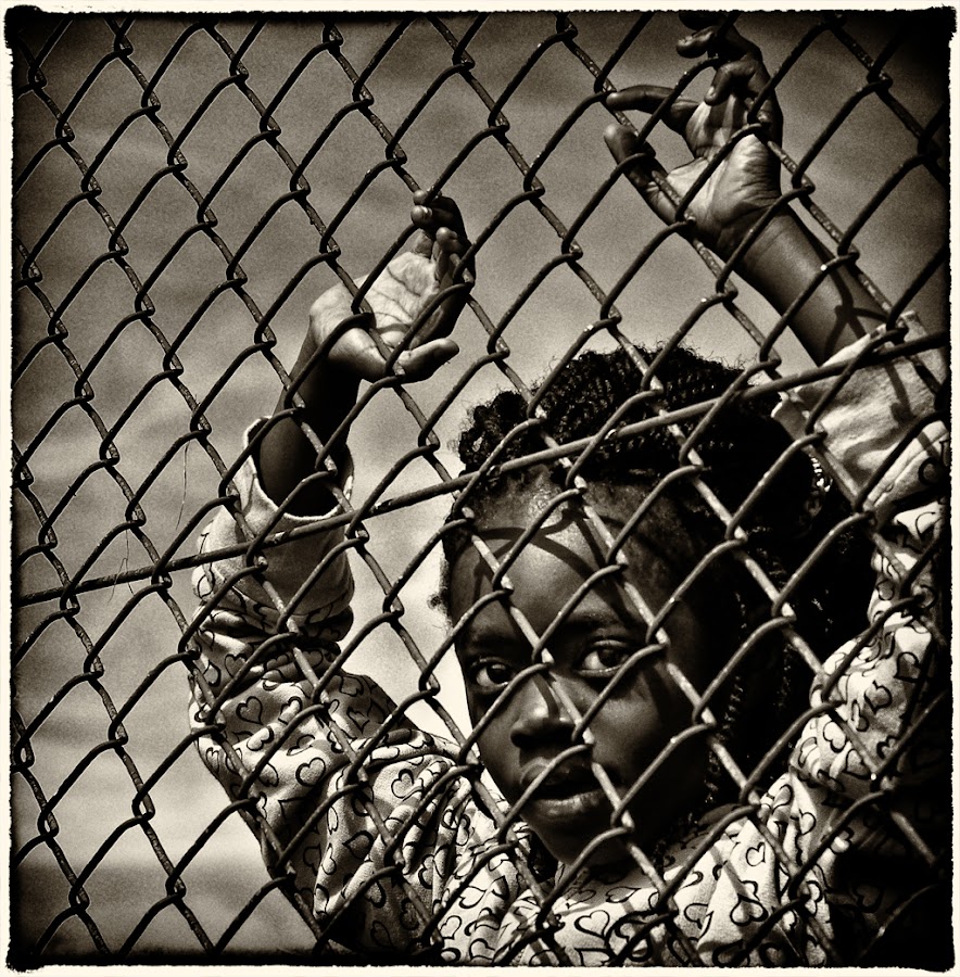 by Marianna Armata - News & Events World Events ( journalism, fence, girl, black and white, gray scale, marianna armata, black, b/w. sepia )