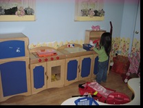 Kaylie in the Playroom Kitchen