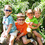 Eli, Aidan, Corrine, and Natalie posing on the gorilla statue in the Cincinnati Zoo.