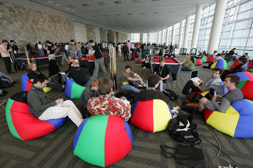 The crew hanging out on beanbags with laptops