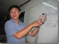 Mr. Vanra Ieng shows a nift enclosure that makes sure the phone plugged in to the computer will be reliably working!