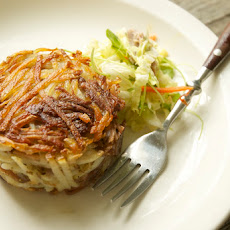 Potato and Pork Confit Cakes with Wilted Napa Cabbage and Cress Slaw