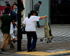 Her arm must get tired carrying a stroller like that.