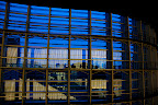 Visitors reflected in the exterior glass wall of The National Art Center, Tokyo