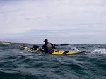 Leon Somme sprinting to catch a wind wave in a Romany sea kayak on Lake Michigan.