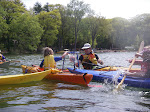 Osa Svennson and Jim Svennson playing kayak polo. Osa scores a point.