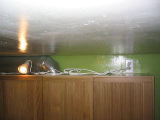 The outlet I added above the cabinets for the spotlights. I connected the outlet directly to the light switch below it.
