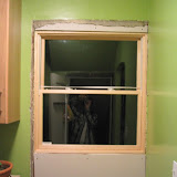 Interior view of the pantry window. I told the contractor I’d take care of the interior patching, since I’m comfortable doing that work. So far I’ve just cut and mounted the drywall. (We’ve temporarily removed the cabinets from under the window.)