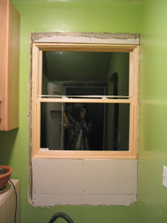Interior view of the pantry window. I told the contractor I’d take care of the interior patching, since I’m comfortable doing that work. So far I’ve just cut and mounted the drywall. (We’ve temporarily removed the cabinets from under the window.)