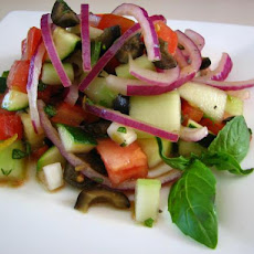 Cucumber Tomato Salad With Zucchini and Black Olives and a Lemon