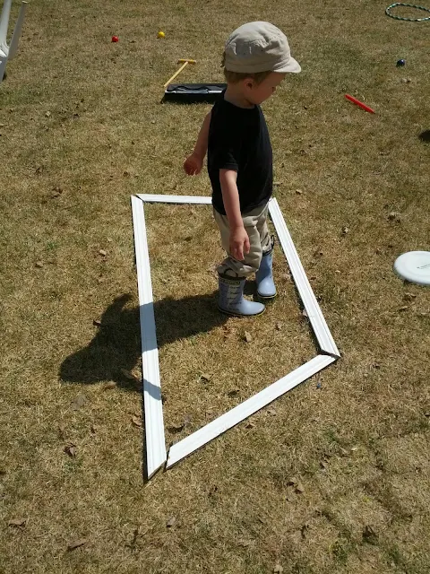 Kid standing inside a giant outdoor letter he built