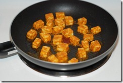 Fry paneer until golden-brown on both sides