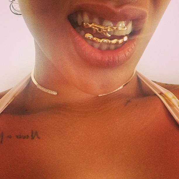 PHOTOS Rihanna Shows Off Gold AK47 Grill On Her Teeth Bringing The.