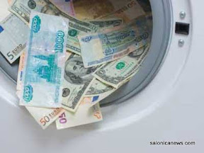 Money laundering. Money cleaning concept. Washing US dollars, euro, russian roubles