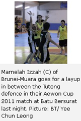 Marnelah Izzah (C) of Brunei-Muara goes for a layup in between the Tutong defence in their Aewon Cup 2011 match at Batu Bersurat last night. Picture: BT/ Yee Chun Leong 