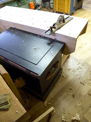 Here I'm using my tool chest to brace a workbench as I flatten its top with a jointer plane.