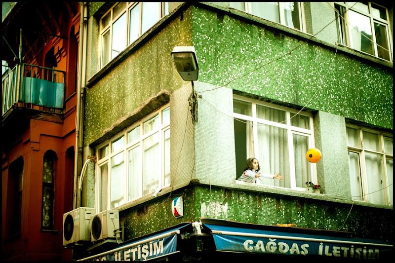 child with ball apartment window Istanbul Zoriah