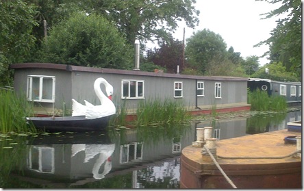 houseboat with swan dinghy