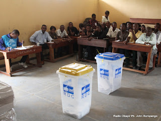 Des témoins des candidats devant les urnes le 28/11/2011 dans un bureau de vote au quartier Makelele dans la commune de Bandalungwa à Kinshasa, pour les élections de 2011 en RDC. Radio Okapi/ Ph. John Bompengo