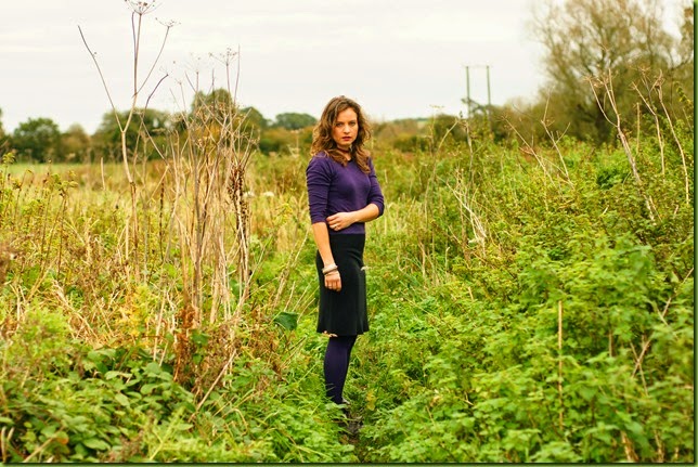 purple bodycon dress in a field