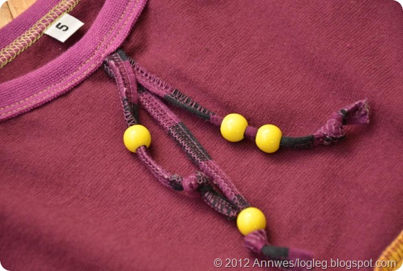 Dress decorated with beads on a jersey cord