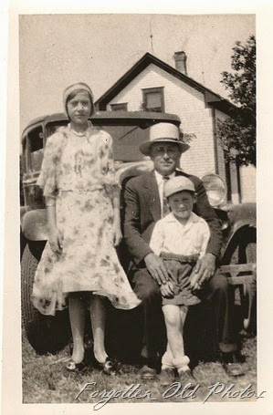Man and two kids DL Antiques Model A maybe