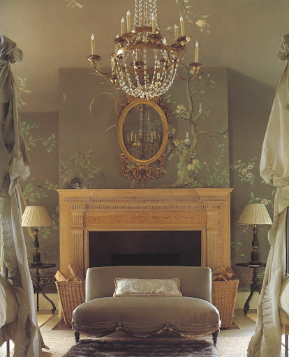 The high ceilings, French chandelier, satin settee and old stripped mantel make this master bedroom a theatrical space.