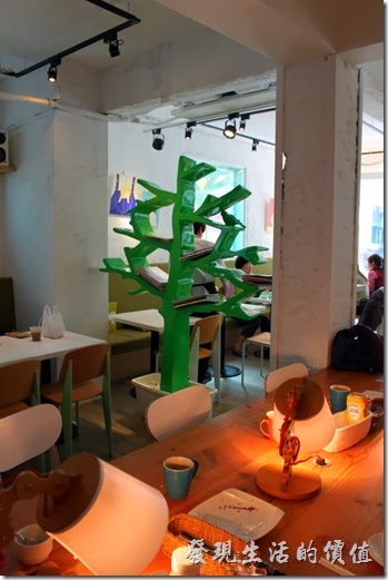 台南-小莫里。這個樹狀的書架屏風把餐廳大致上隔成兩部份，這裡還提供USB充電區，就甘心！