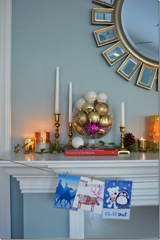 Use Christmas Cards, candles, and place ornaments in apothecary jars for a warm and inviting Holiday mantel.