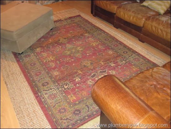layered rug with old rug on sisal