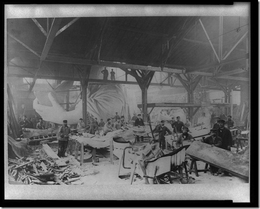 Workmen constructing the Statue of Liberty in Bartholdi's Parisian warehouse workshop; first model; left hand; and quarter-size head--Winter 1882. Photo from the Library of Congress.