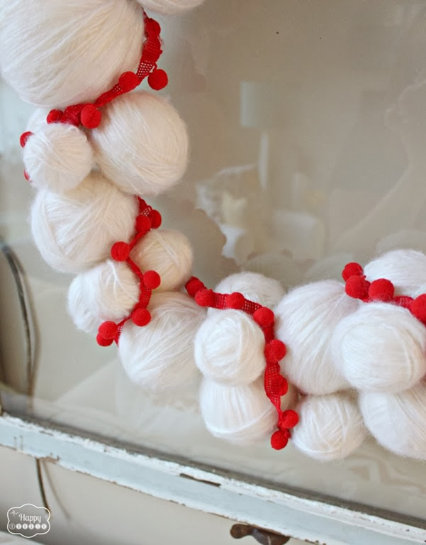 Yarn-Snowball-Christmas-Wreath-with-pom-pom-trim-3-at-thehappyhousie-801x1024