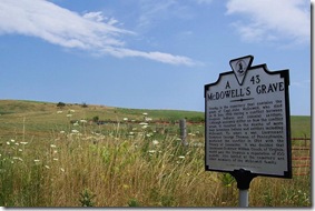 McDowell's Grave marker with family cemetery in background