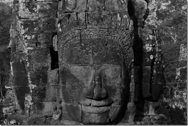 A Smiling Bayon Face surrounded by other faces, Cambodia
