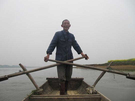 A Chinese man patrolling a lake for illegal fishing