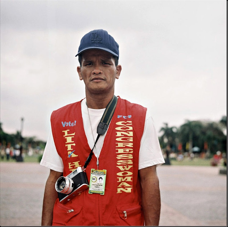 Portrait of a Luneta park photographer offering photo souvenir services to tourists and passersby.