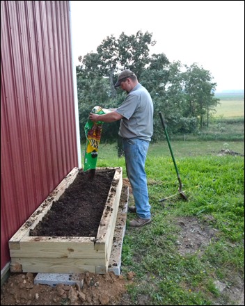 add potting soil to herb garden