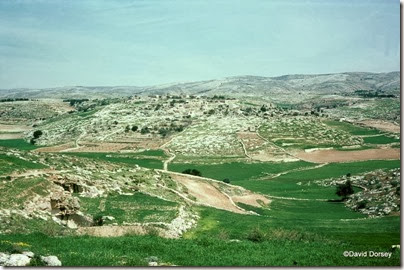 1 View of Kh el Qom from W--view E, with caves on left dd