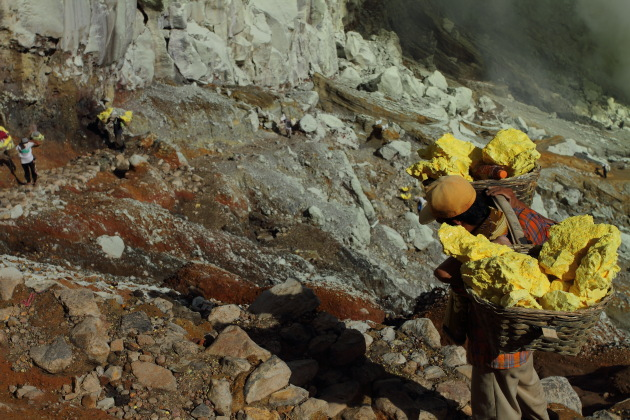 Carrying a heavy sulphur load in hellish conditions at Kawah Ijen, Indonesia