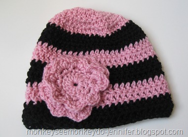 pink and black striped hat with flower