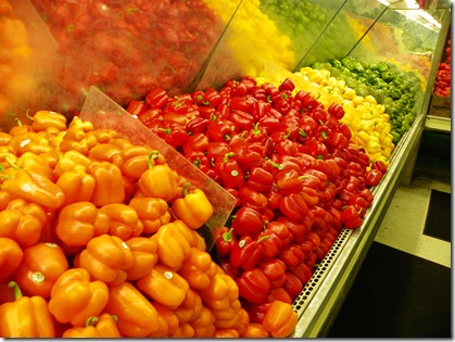 Peppers in various stages of ripeness:  orange, red, yellow, green.