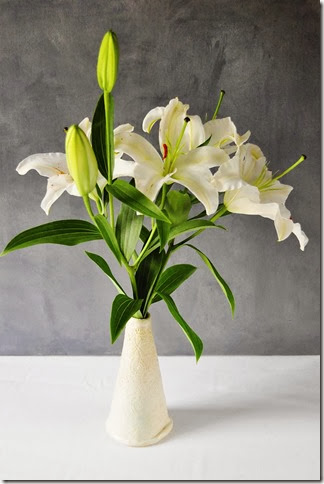 lilies in cone vase