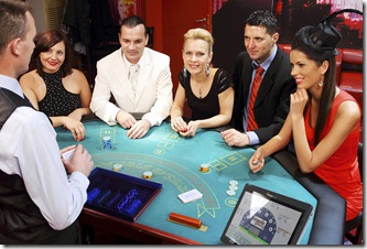 Attractive people having fun at the Blackjacks table. 