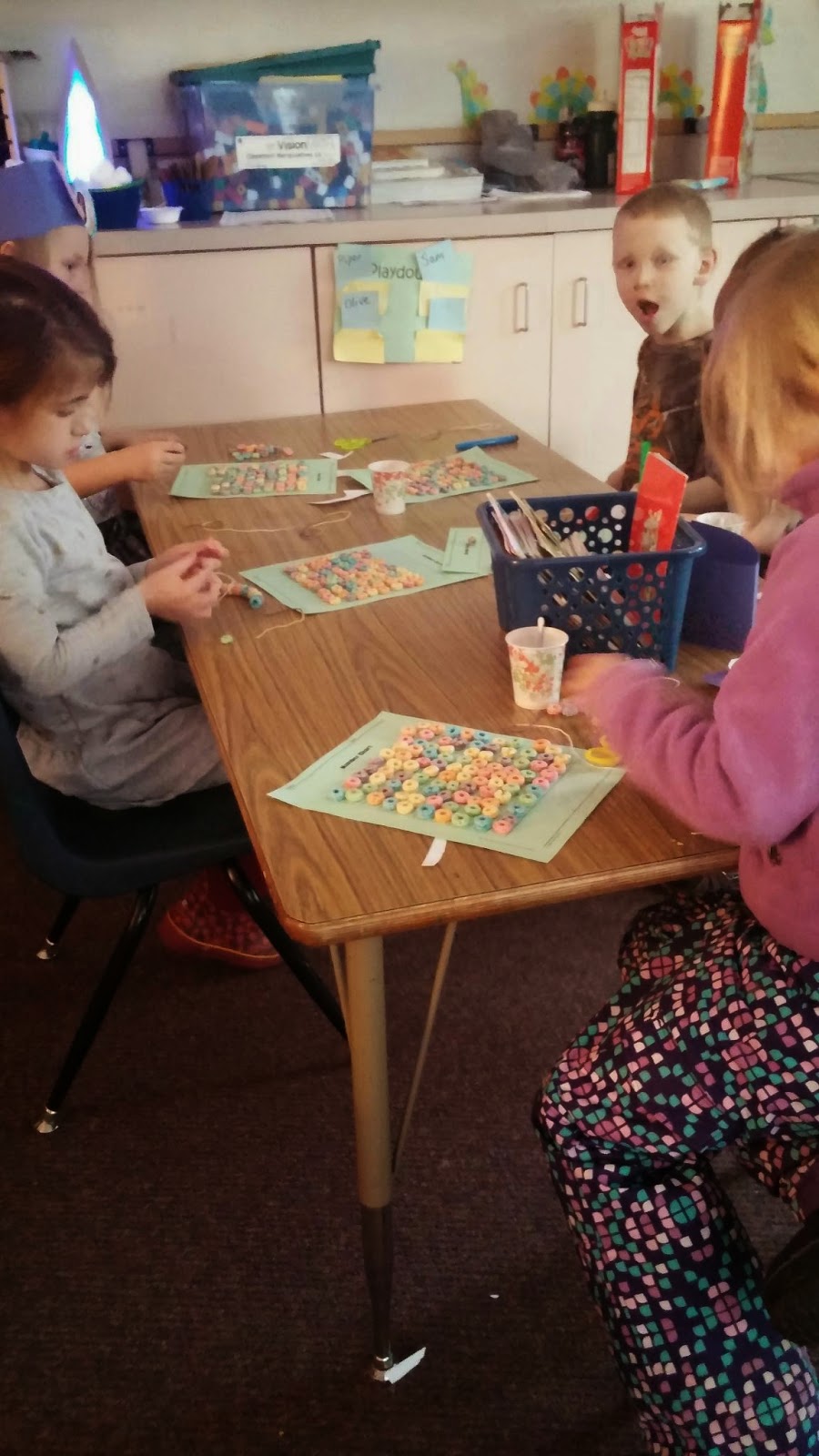 Kindergarten with Ms. Evenson! Happy 100th day! Making 100 fruit loop